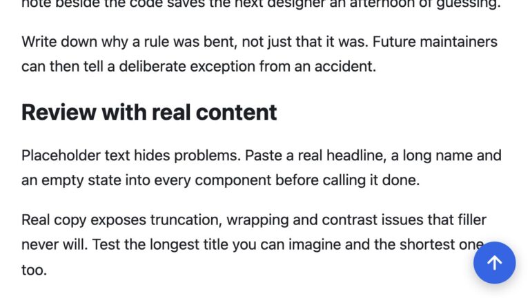 Close-up of an article page scrolled down with a round blue back-to-top button in the bottom right corner